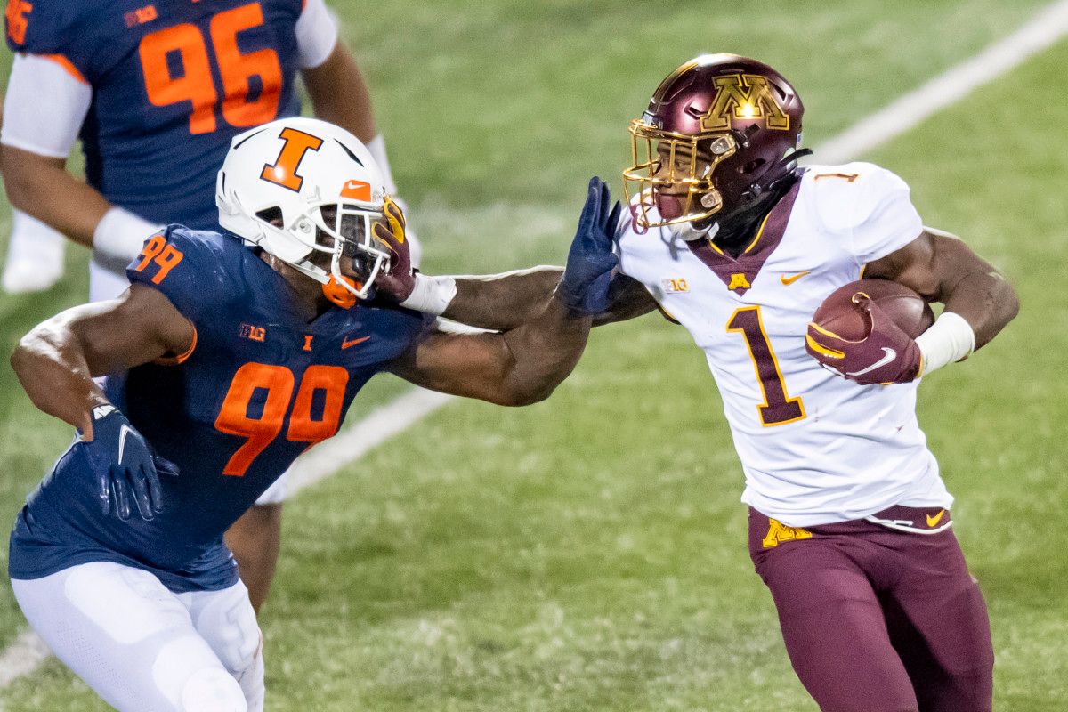 Minnesota Golden Gophers running back Cam Wiley (1) stiff arms Illinois Fighting Illini defensive lineman Owen Carney Jr. (99) during the second half at Memorial Stadium.