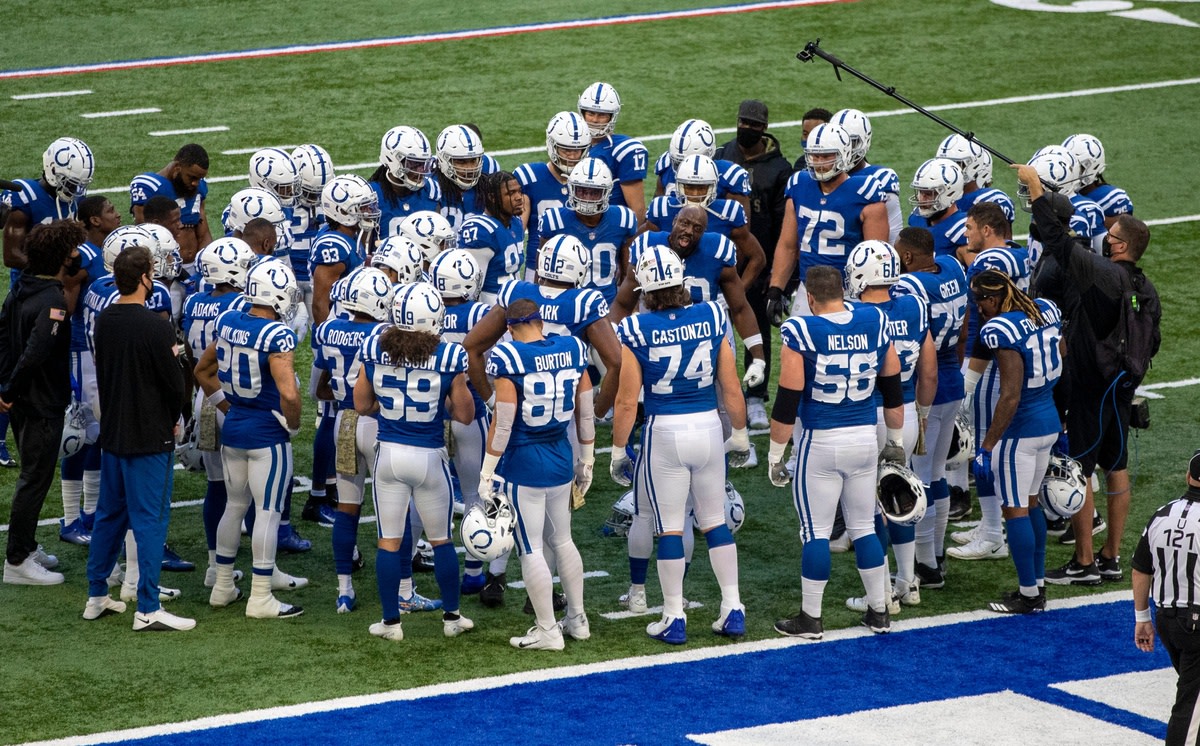 The Indianapolis Colts listen to defensive end Justin Houston's pregame pep talk before Sunday's 24-10 home loss to the Baltimore Ravens at Lucas Oil Stadium.