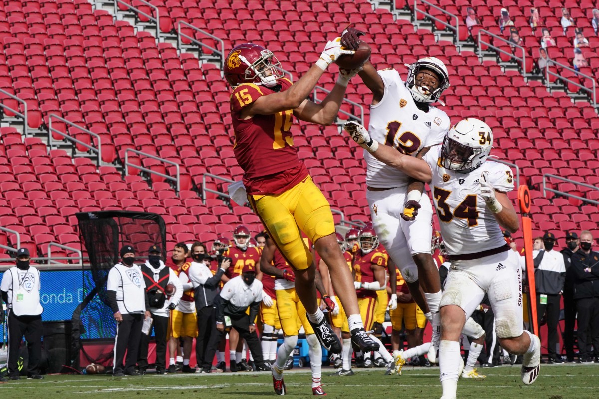 Nov 7, 2020; Los Angeles CA, USA; Southern California Trojans wide receiver Drake London (15) catches a 21-yard touchdown pass for the winning score with 1:20 to play as Arizona State Sun Devils defensive back Kejuan Markham (12) and linebacker Kyle Soelle (34) defend at the Los Angeles Memorial Coliseum. USC defeated Arizona State 28-27.