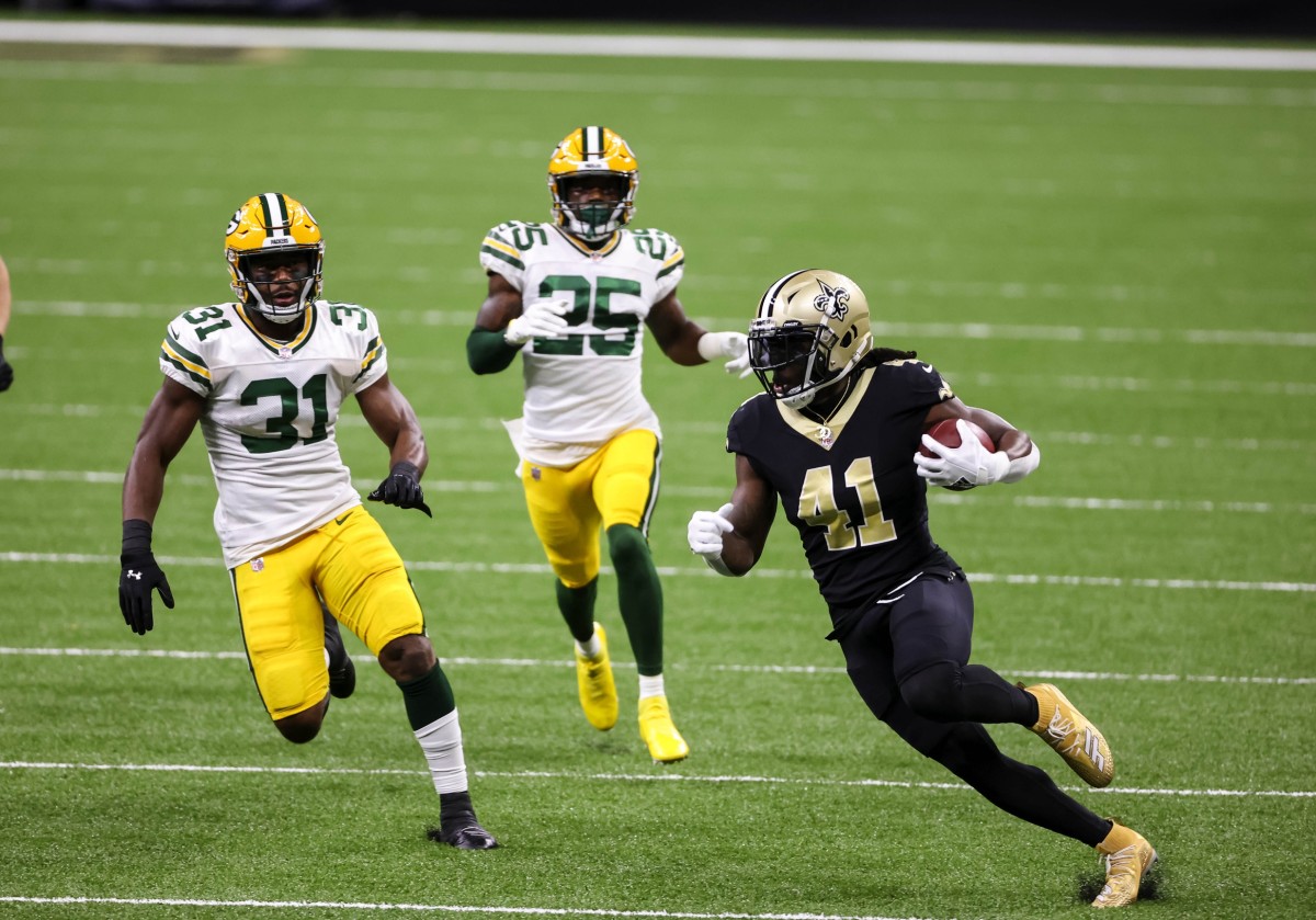 Sep 27, 2020; New Orleans, Louisiana, USA; New Orleans Saints running back Alvin Kamara (41) breaks past Green Bay Packers safety Adrian Amos (31) and cornerback Parry Nickerson (35) during the first quarter at the Mercedes-Benz Superdome. Mandatory Credit: Derick E. Hingle-USA TODAY Sports