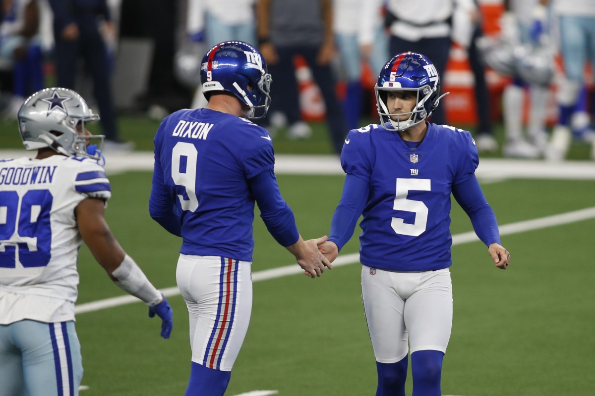 Oct 11, 2020; Arlington, Texas, USA; New York Giants kicker Graham Gano (5) is congratulated by holder Riley Dixon (9) after kicking a field goal in the first half against the Dallas Cowboys at AT&T Stadium.