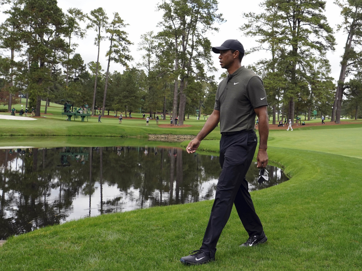 Tiger Woods walks to the Sarazen Bridge on the 15th hole during the first round of The Masters golf tournament