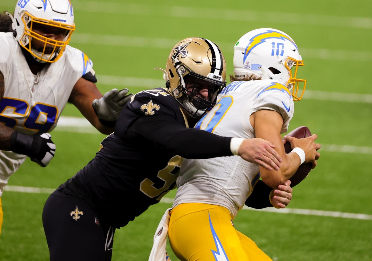 Oct 12, 2020; New Orleans, Louisiana, USA; New Orleans Saints defensive end Trey Hendrickson (91) sacks Los Angeles Chargers quarterback Justin Herbert (10) during the first quarter at the Mercedes-Benz Superdome. Mandatory Credit: Derick E. Hingle-USA TODAY 