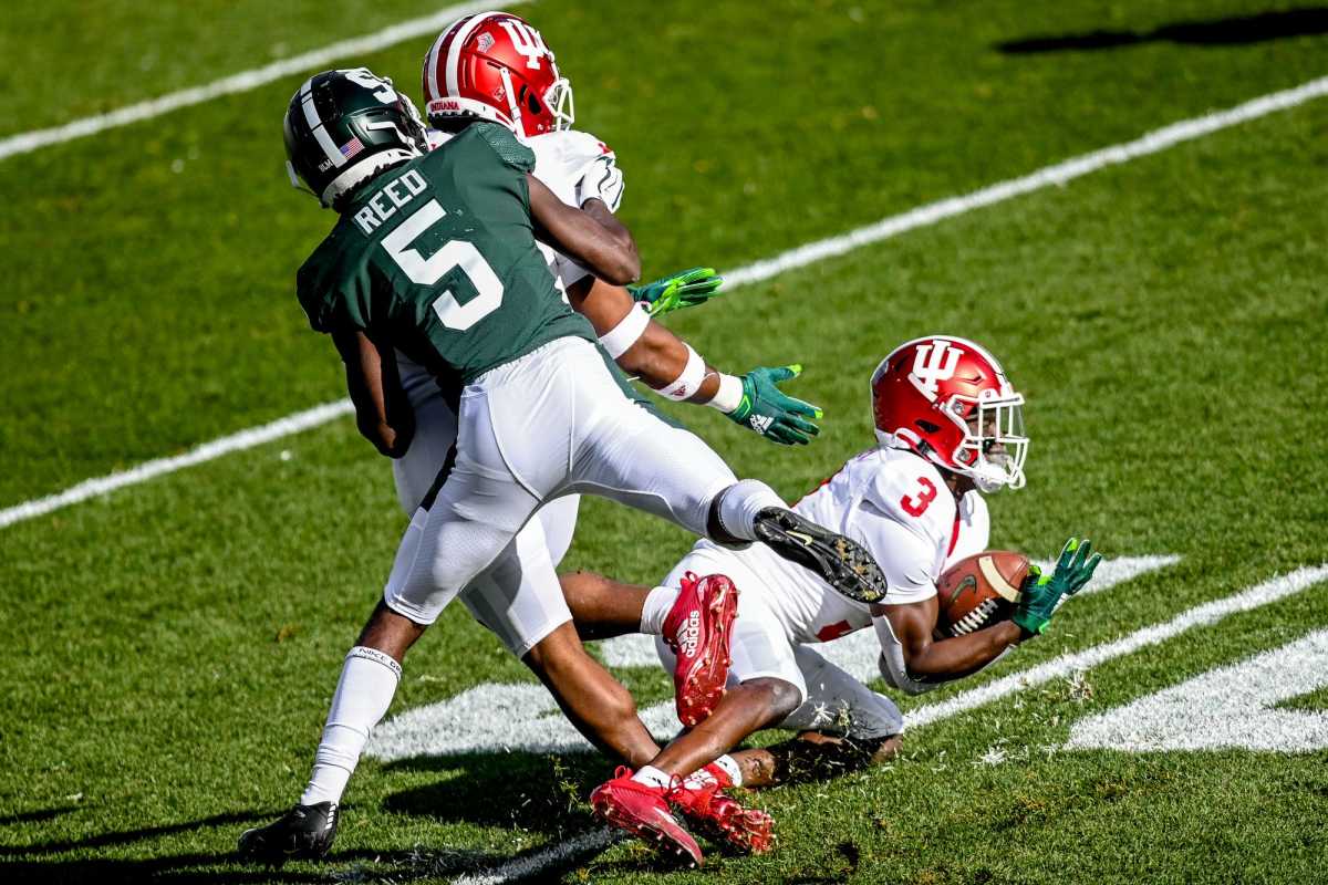 Michigan State's Indiana's Tiawan Mullen, right, intercepts a pass intended for Michigan State's Jayden Reed during the first quarter on Saturday, Nov. 14, 2020, at Spartan Stadium in East Lansing.