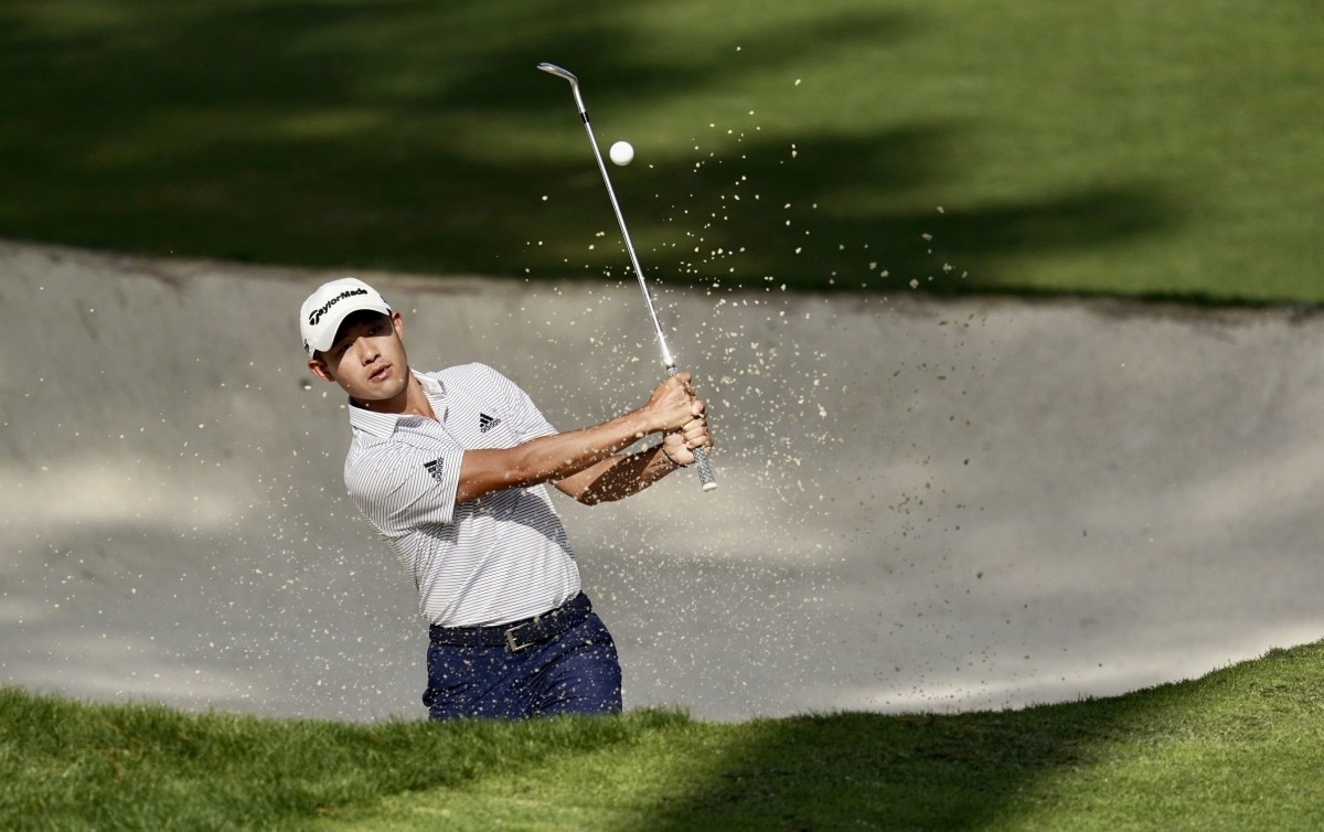Collin Morikawa chips out of a bunker at Augusta National