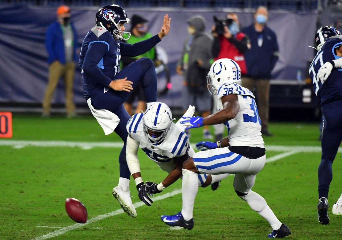 E.J. Speed blocks Trevor Daniel's punt, which T.J. Carrie (38) scooped and scored on from 6 yards out to give the Indianapolis Colts a 27-17 lead on the Tennessee Titans in the third quarter.