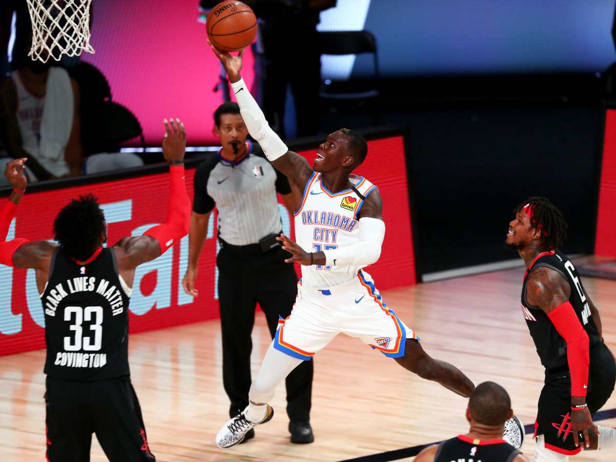 Aug 24, 2020; Lake Buena Vista, Florida, USA; Oklahoma City Thunder guard Dennis Schroder (17) shoots over Houston Rockets forward Robert Covington (33) during the first half in game four of the first round of the 2020 NBA Playoffs at AdventHealth Arena.