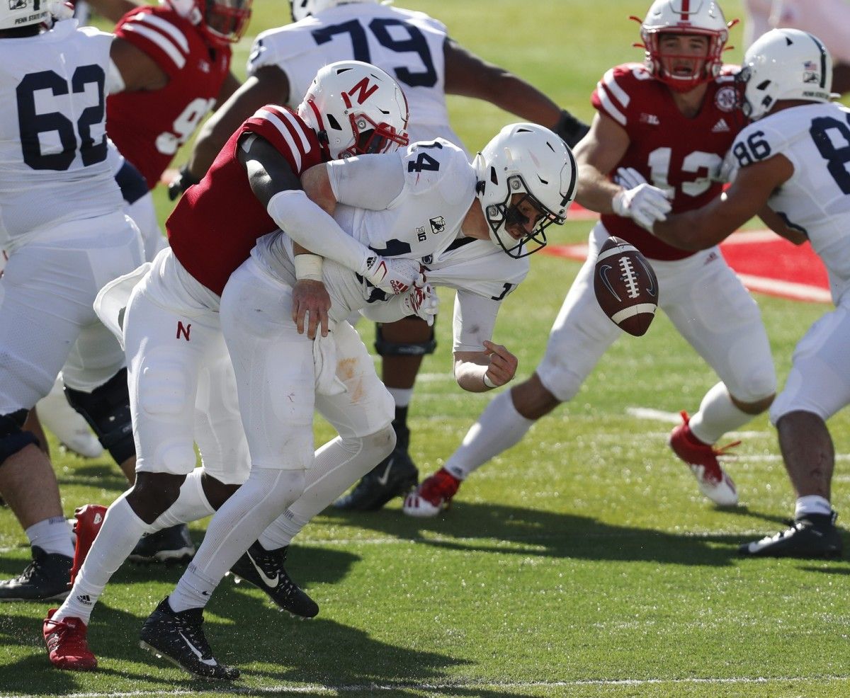 Nebraska safety Deontai Williams (8) forces a fumble against Penn State quarterback Sean Clifford (14) in the first half on Saturday. (Bruce Thorson/USA TODAY Sports)