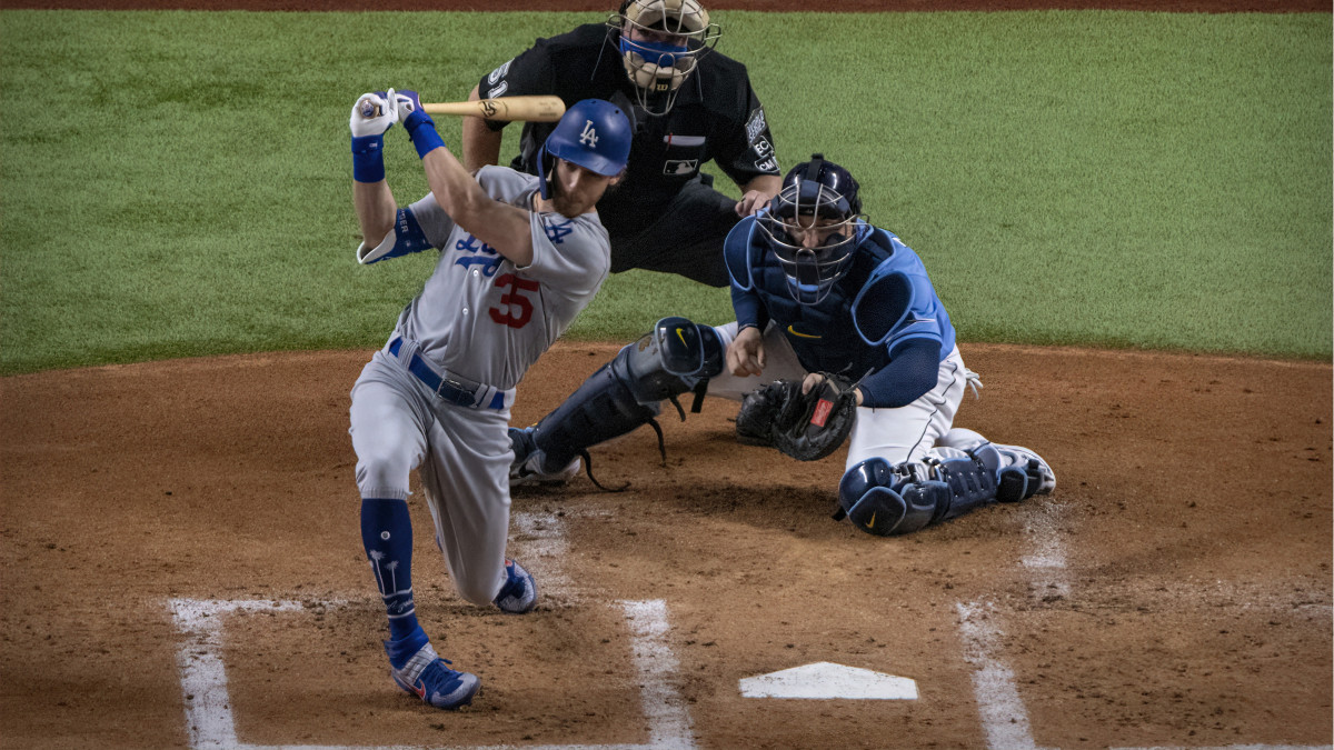 Los Angeles Dodgers center fielder Cody Bellinger (35) hits a single and drives in a run against the Tampa Bay Rays during the first inning in game five of the 2020 World Series at Globe Life Field.