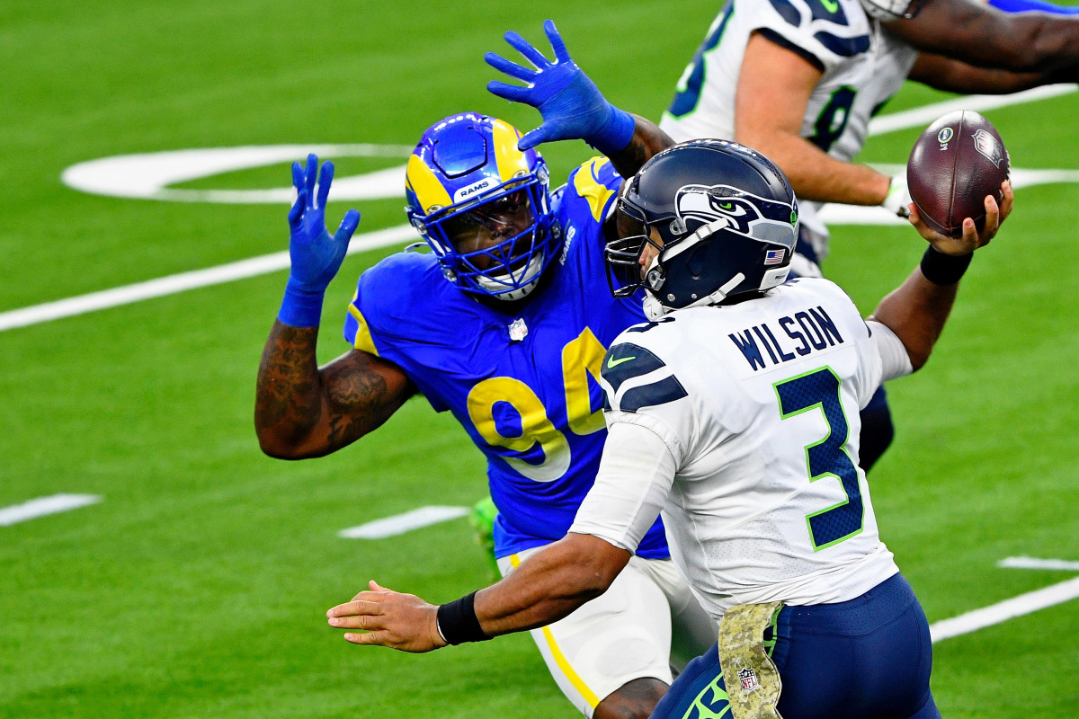 Seattle Seahawks quarterback Russell Wilson (3) prepares to throw as Los Angeles Rams defensive tackle A'Shawn Robinson (94) closes in during the second half at SoFi Stadium.