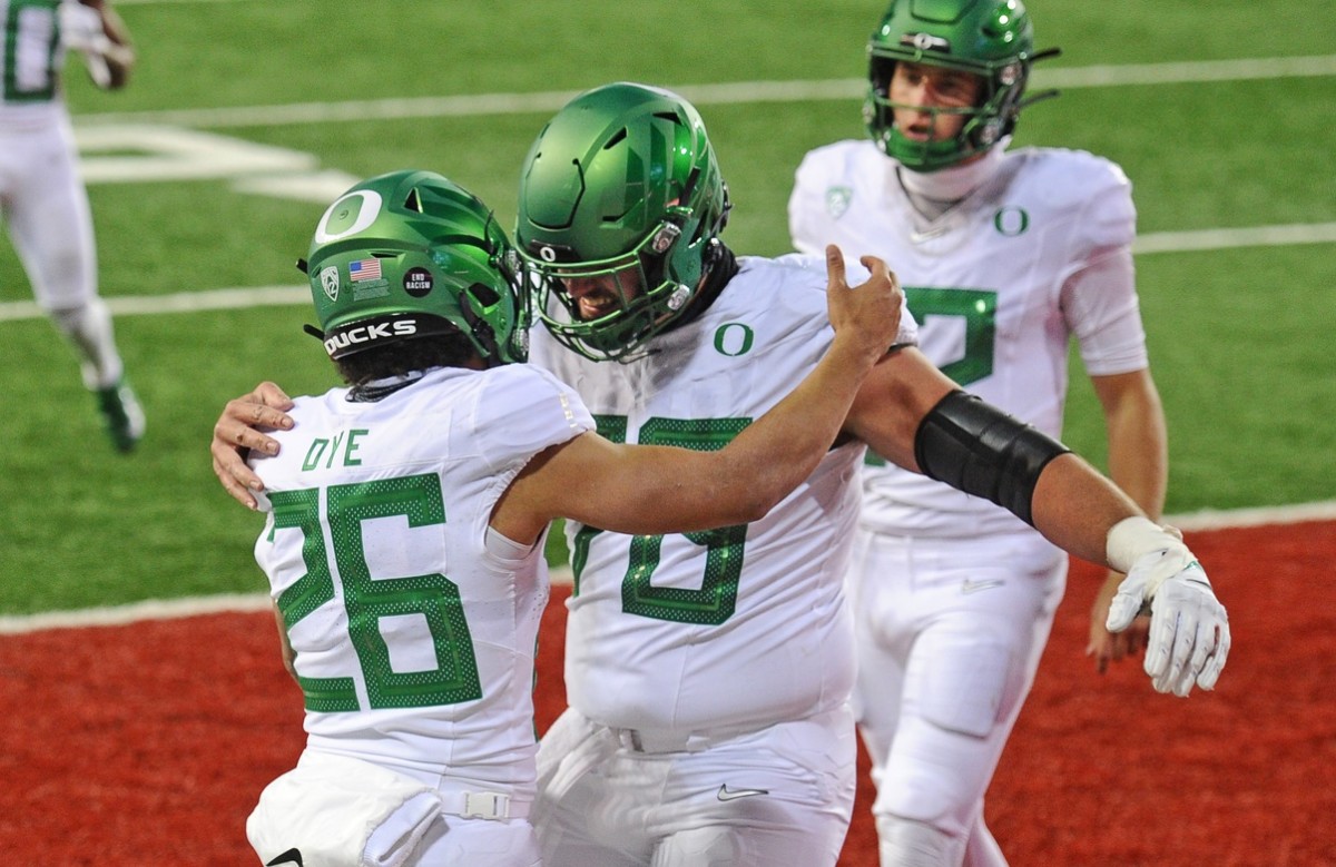 Nov 14, 2020; Pullman, Washington, USA; Oregon Ducks running back Travis Dye (26) and Oregon Ducks offensive lineman Chris Randazzo (79) celebrate a touchdown against the Washington State Cougars in the second half at Martin Stadium. Oregon won 43-29.