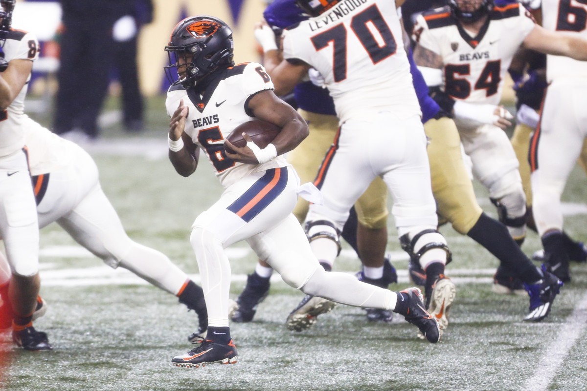 Nov 14, 2020; Seattle, Washington, USA; Oregon State Beavers running back Jermar Jefferson (6) rushes against the Washington Huskies during the second quarter at Alaska Airlines Field at Husky Stadium.