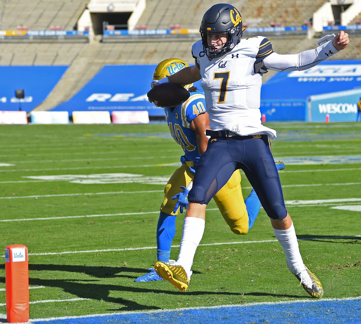 Nov 15, 2020; Pasadena, California, USA; California Golden Bears quarterback Chase Garbers (7) scores a touchdown against the UCLA Bruins in the first half at the Rose Bowl.