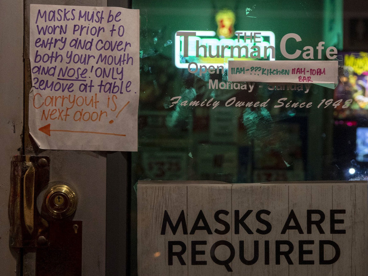 A sign at Thurman's Cafe in Columbus tells patrons masks are required