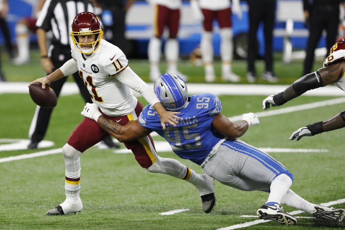 Washington Football Team quarterback Alex Smith gets sacked by Lions defensive end Romeo Okwara. 