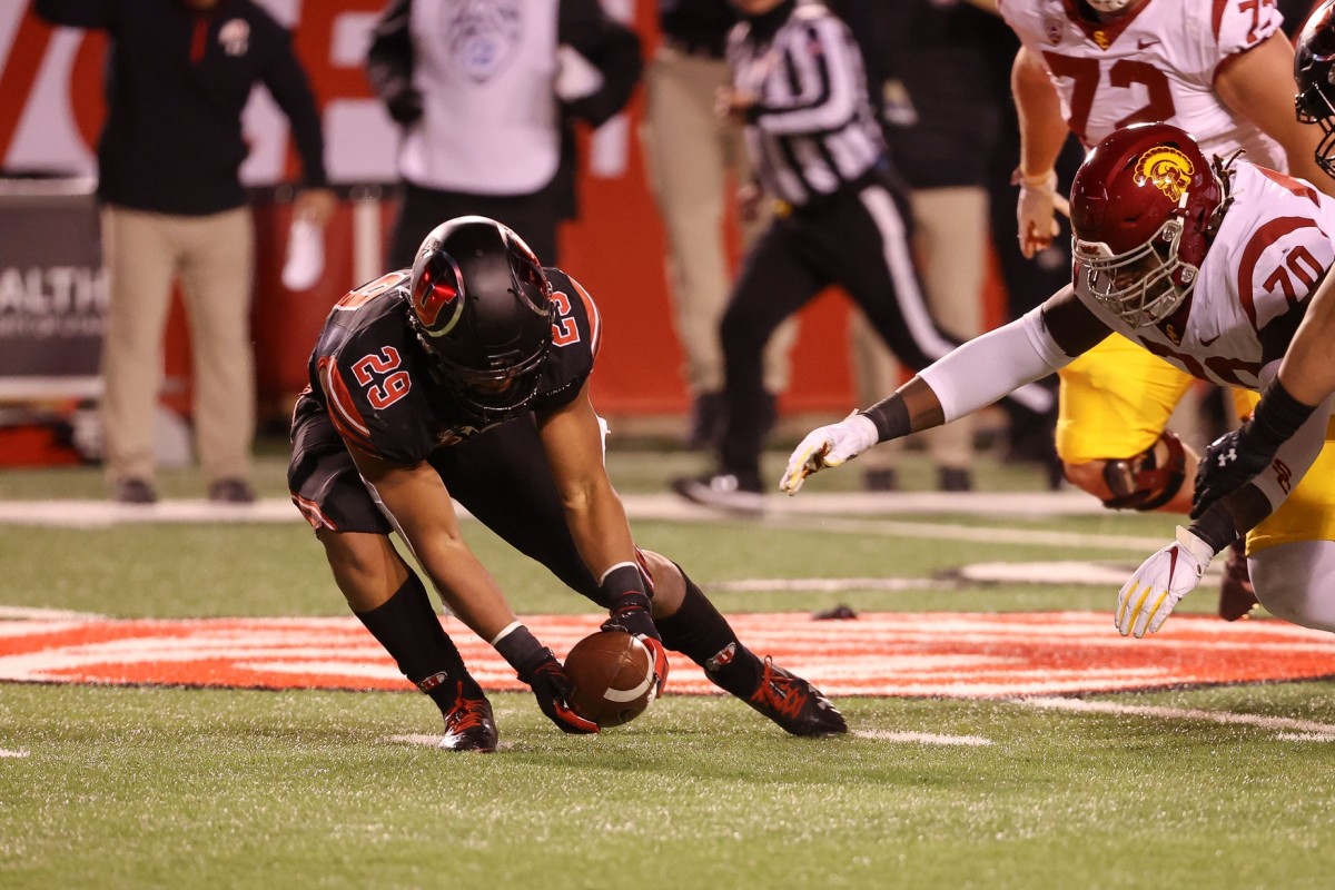 Nov 21, 2020; Salt Lake City, Utah, USA; Utah Utes linebacker Nephi Sewell (29) picks up the fumble and runs to the end zone against the USC Trojans at Rice-Eccles Stadium.