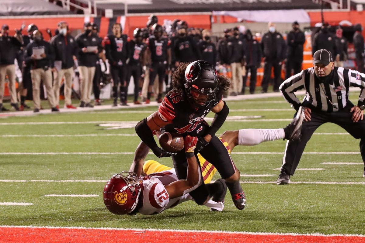 Nov 21, 2020; Salt Lake City, Utah, USA; Utah Utes wide receiver Samson Nacua (45) pushes into the end zone while being held by USC Trojans safety Isaiah Pola-Mao (21) during the second quarter at Rice-Eccles Stadium.