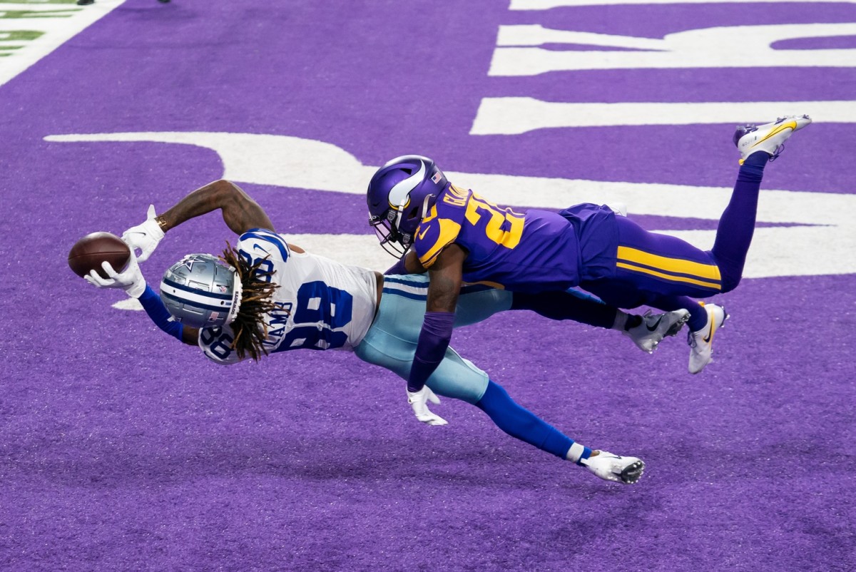 Nov 22, 2020; Minneapolis, Minnesota, USA; Dallas Cowboys wide receiver CeeDee Lamb (88) catches a pass for a touchdown against Minnesota Vikings defensive back Jeff Gladney (20) in the second quarter at U.S. Bank Stadium.