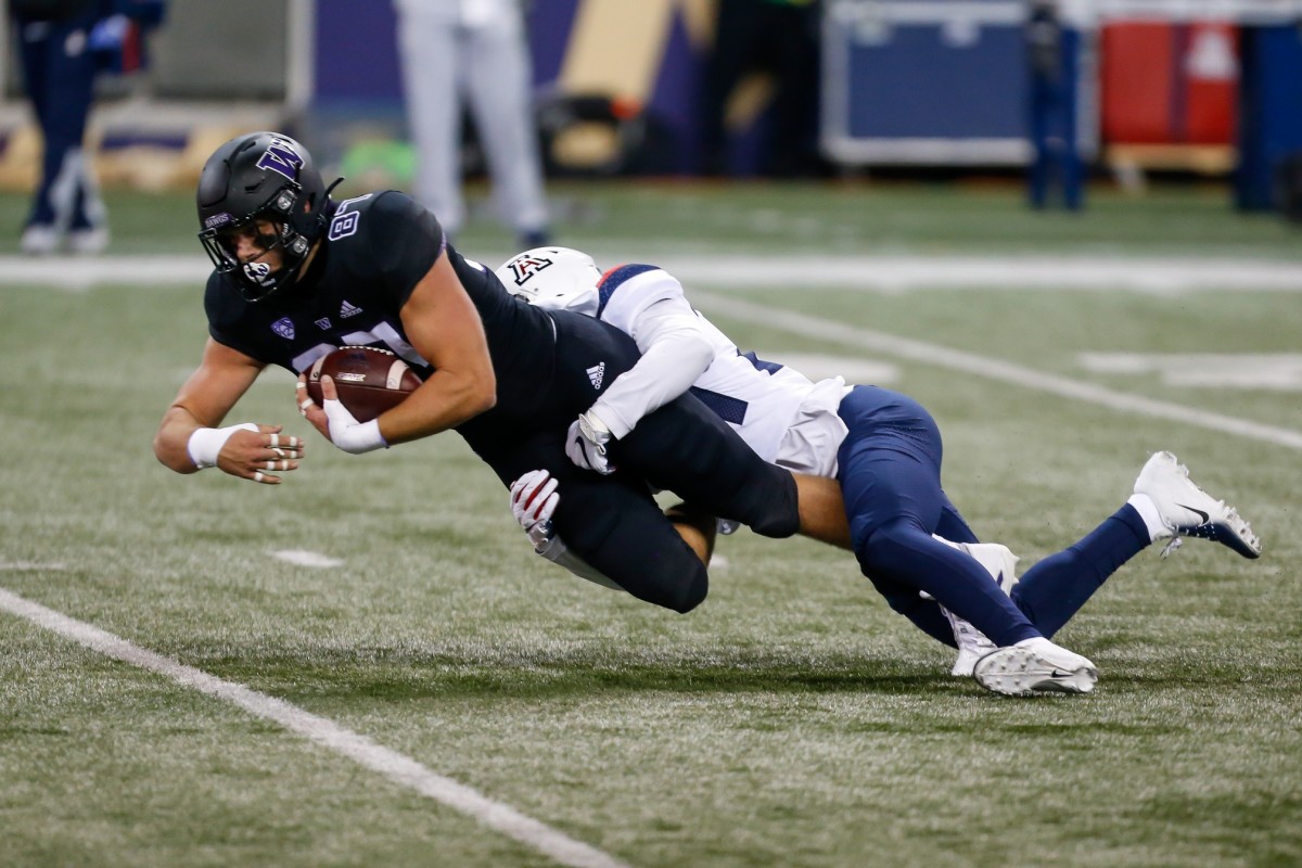 Nov 21, 2020; Seattle, Washington, USA; Washington Huskies tight end Cade Otton (87) is tackled by Arizona Wildcats defensive back Rhedi Short (24) during the first quarter at Alaska Airlines Field at Husky Stadium.