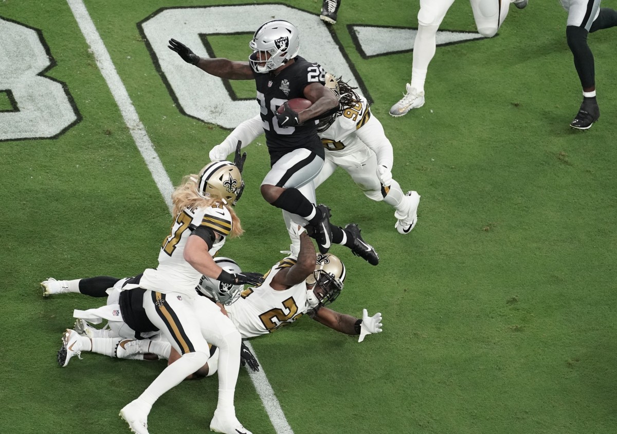 Sep 21, 2020; Paradise, Nevada, USA; Las Vegas Raiders running back Josh Jacobs (28) is tackled by New Orleans Saints defensive tackle Malcom Brown (90) during the first quarter of a NFL game at Allegiant Stadium. Mandatory Credit: Kirby Lee-USA TODAY Sports