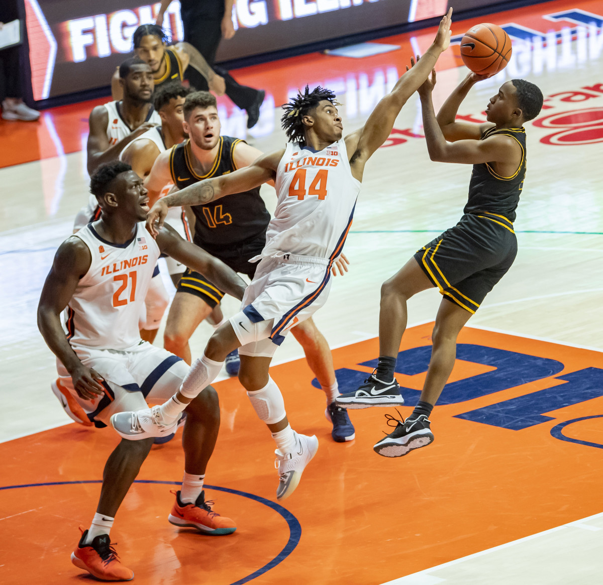North Carolina A&T Aggies guard Fred Cleveland Jr. (right) goes up for a shot as Illinois Fighting Illini guard Adam Miller (44) defends during the first half at the State Farm Center.