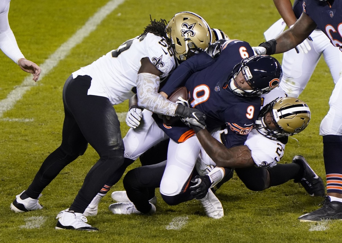 Nov 1, 2020; Chicago, Illinois, USA; New Orleans Saints outside linebacker Demario Davis (56) sacks Chicago Bears quarterback Nick Foles (9) during the third quarter at Soldier Field. Mandatory Credit: Mike Dinovo-USA TODAY Sports