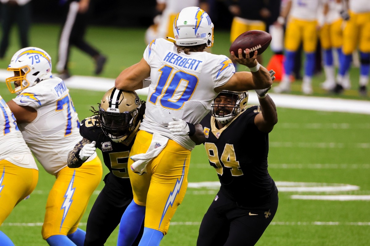 Oct 12, 2020; New Orleans, Louisiana, USA; New Orleans Saints linebacker Demario Davis (56) and defensive end Cameron Jordan (94) pressure Los Angeles Chargers quarterback Justin Herbert (10) on a throw during the second half at the Mercedes-Benz Superdome. Mandatory Credit: Derick E. Hingle-USA TODAY 