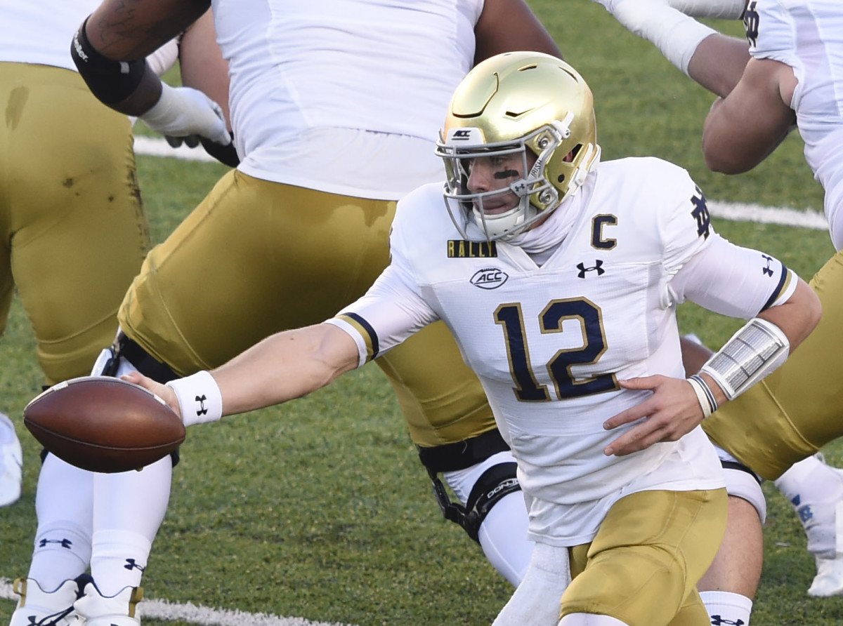 Notre Dame Fighting Irish quarterback Ian Book (12) with the ball in the first quarter at Kenan Memorial Stadium.