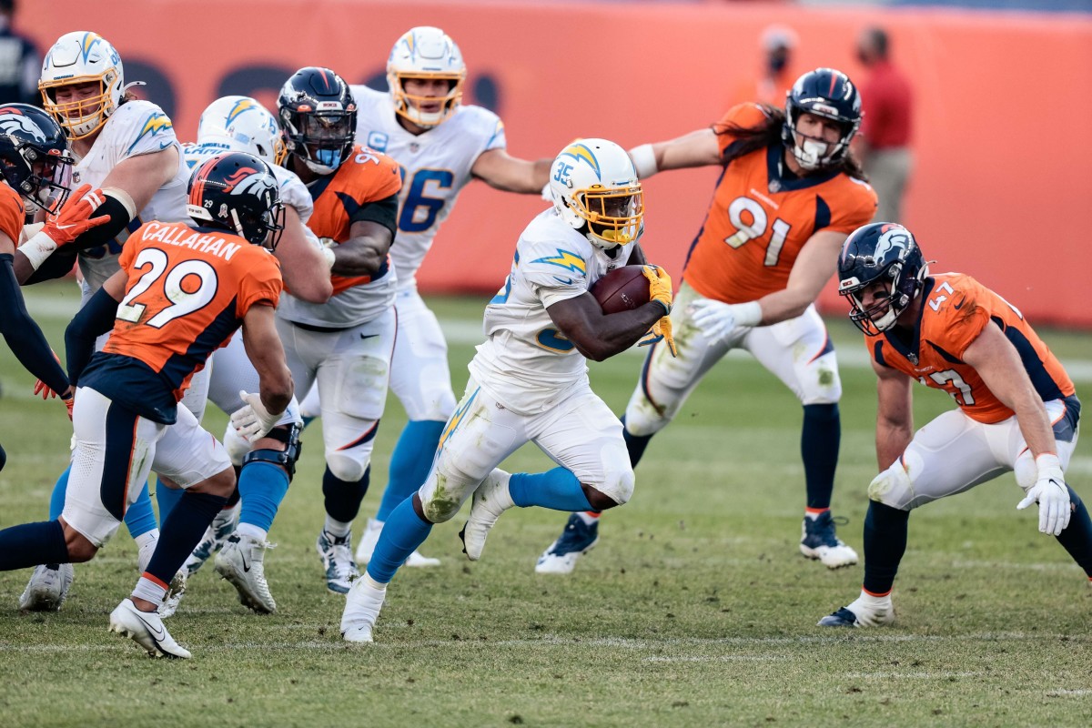Nov 1, 2020; Denver, Colorado, USA; Los Angeles Chargers running back Troymaine Pope (35) runs the ball against Denver Broncos inside linebacker Josey Jewell (47) and cornerback Bryce Callahan (29) in the third quarter at Empower Field at Mile High. Mandatory Credit: Isaiah J. Downing-USA TODAY 