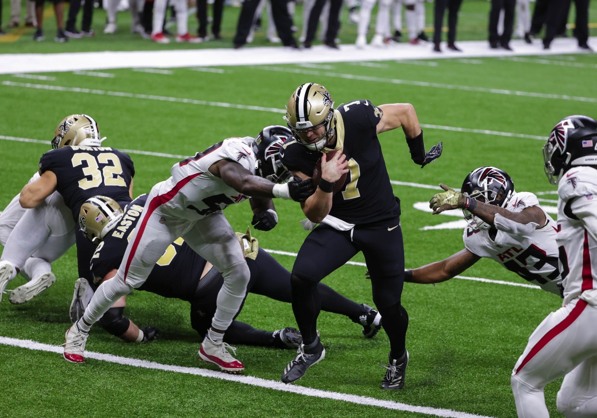 Nov 22, 2020; New Orleans, Louisiana, USA; New Orleans Saints quarterback Taysom Hill (7) scores against the Atlanta Falcons during the second half at the Mercedes-Benz Superdome. Mandatory Credit: Derick E. Hingle-USA TODAY 