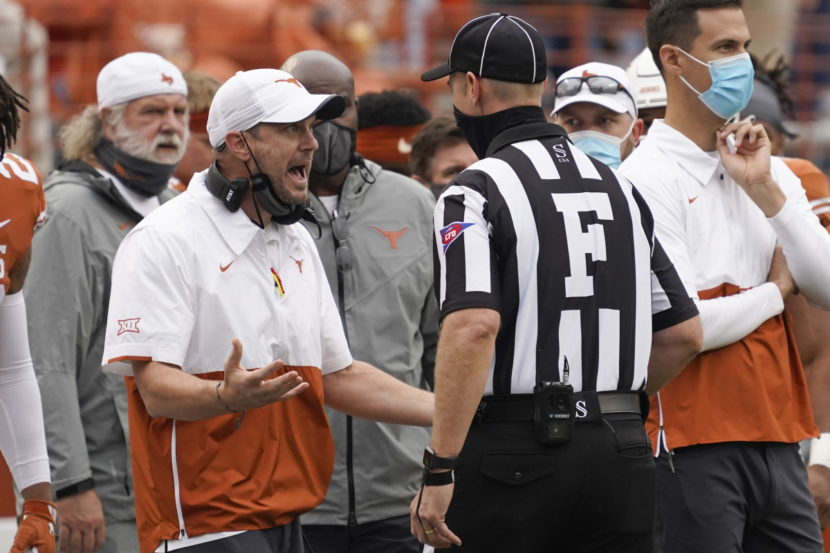 Tom Herman airs his grievances with an official in Texas' 23-20 loss to Iowa State on Friday.