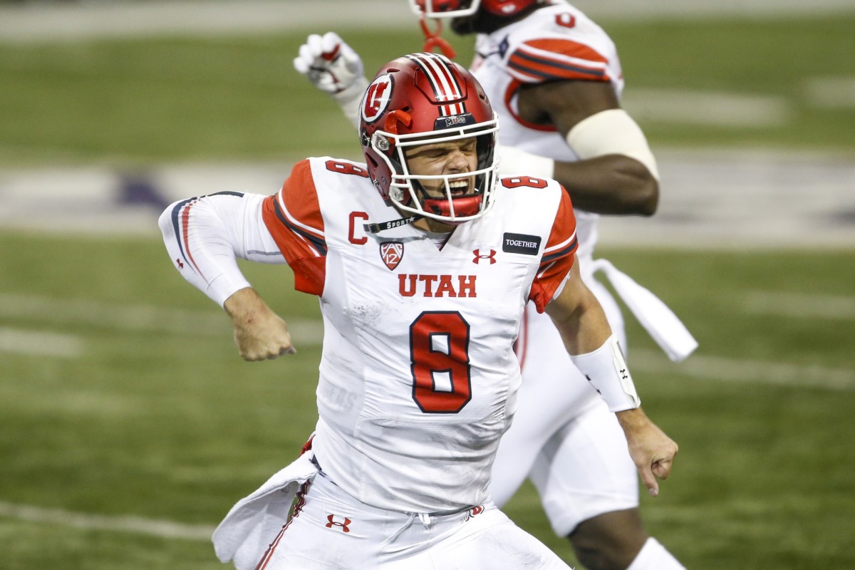 Nov 28, 2020; Seattle, Washington, USA; Utah Utes quarterback Jake Bentley (8) celebrates after rushing for a touchdown against the Washington Huskies during the first quarter at Alaska Airlines Field at Husky Stadium.