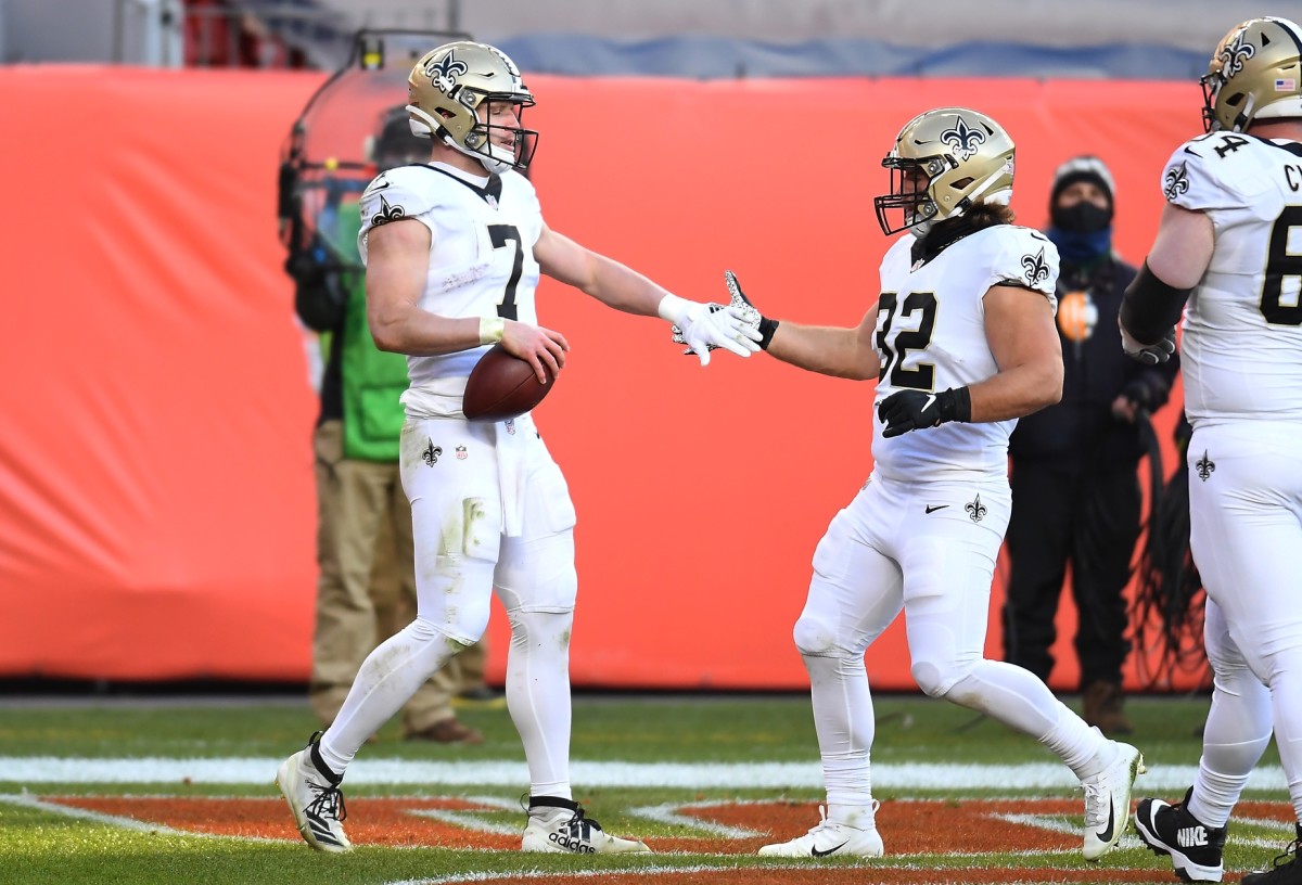 Nov 29, 2020; Denver, Colorado, USA; New Orleans Saints quarterback Taysom Hill (7) celebrates with running back Michael Burton (32) after running for a touchdown against the Denver Broncos in the second quarter at Empower Field at Mile High. Mandatory Credit: Ron Chenoy-USA TODAY Sports