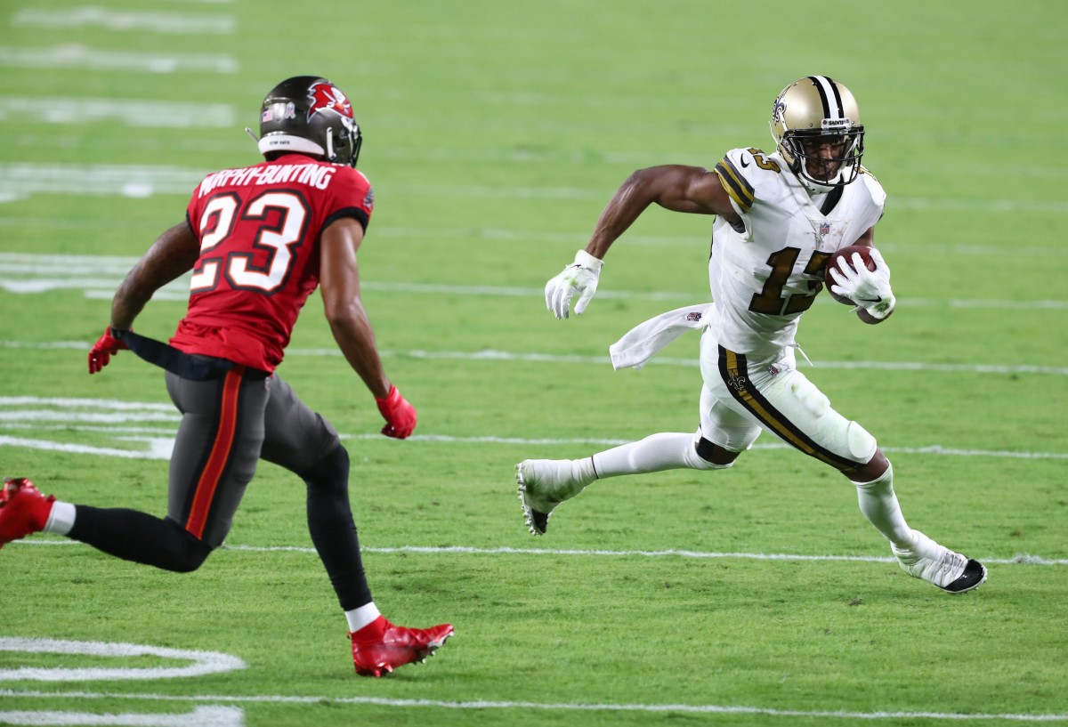 Nov 8, 2020; Tampa, Florida, USA; New Orleans Saints wide receiver Michael Thomas (13) runs the ball against Tampa Bay Buccaneers cornerback Sean Murphy-Bunting (23) in the first quarter of a NFL game at Raymond James Stadium. Mandatory Credit: Kim Klement-USA TODAY 