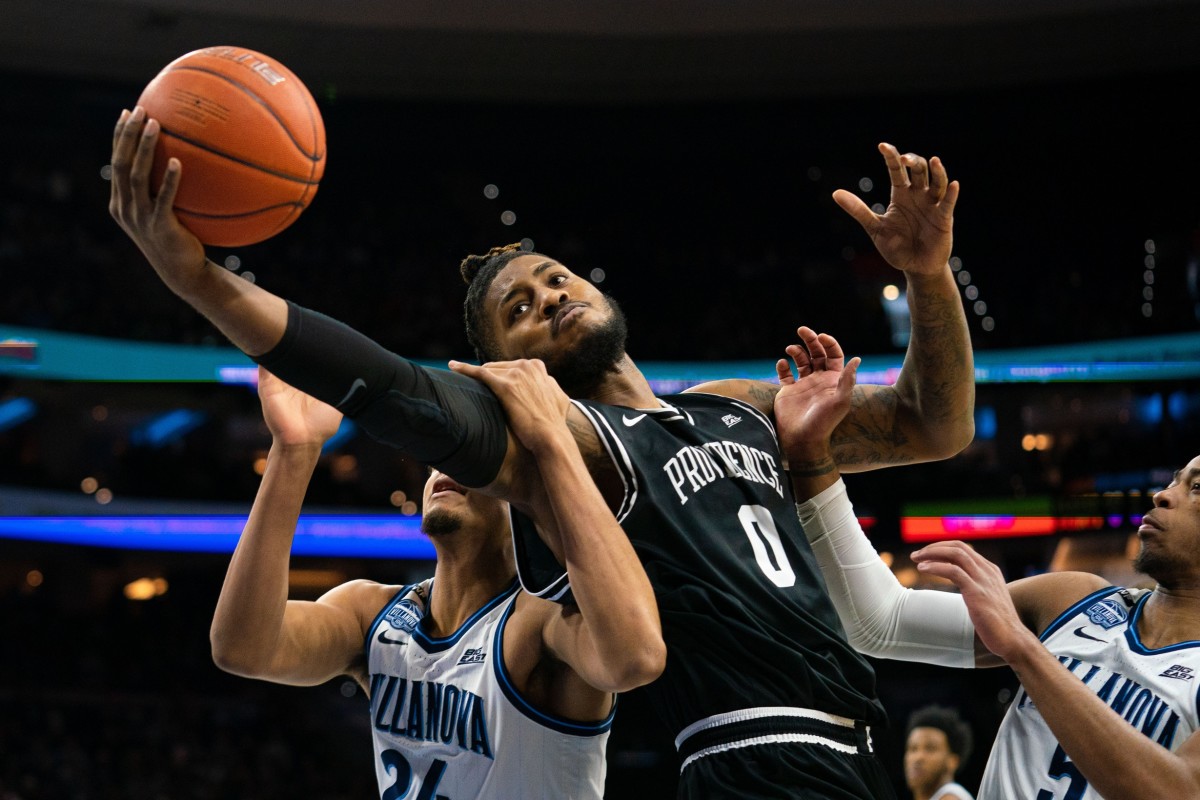 Providence center Nate Watson (0) rebounds the ball in front of Villanova forward Jeremiah Robinson-Earl (24) and guard Justin Moore (5) last February. (USA TODAY Sports)