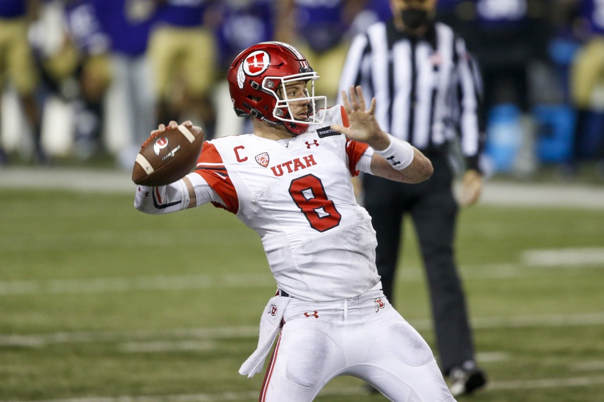 Nov 28, 2020; Seattle, Washington, USA; Utah Utes quarterback Jake Bentley (8) passes for a touchdown against the Washington Huskies during the second quarter at Alaska Airlines Field at Husky Stadium.