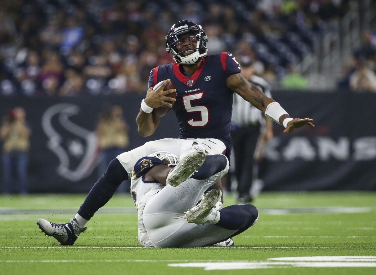 Aug 29, 2019; Houston, TX, USA; Houston Texans quarterback Joe Webb (5) is tackled by Los Angeles Rams linebacker Landis Durham (96) during the third quarter at NRG Stadium.