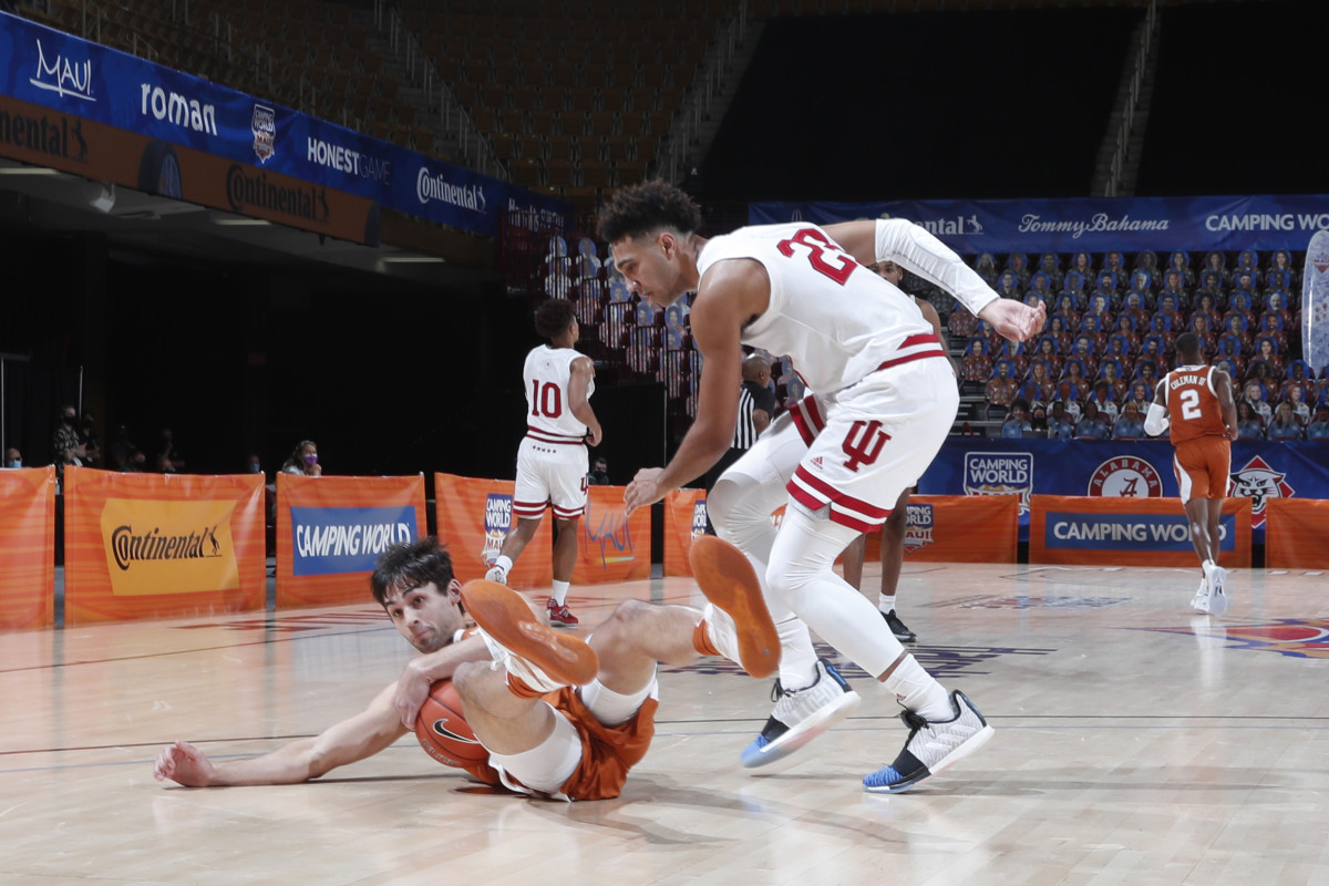 Indiana's Trayce Jackson-Davis (right) fights for a loose ball in the loss to Texas. (Photos courtesy of IU Athletics)