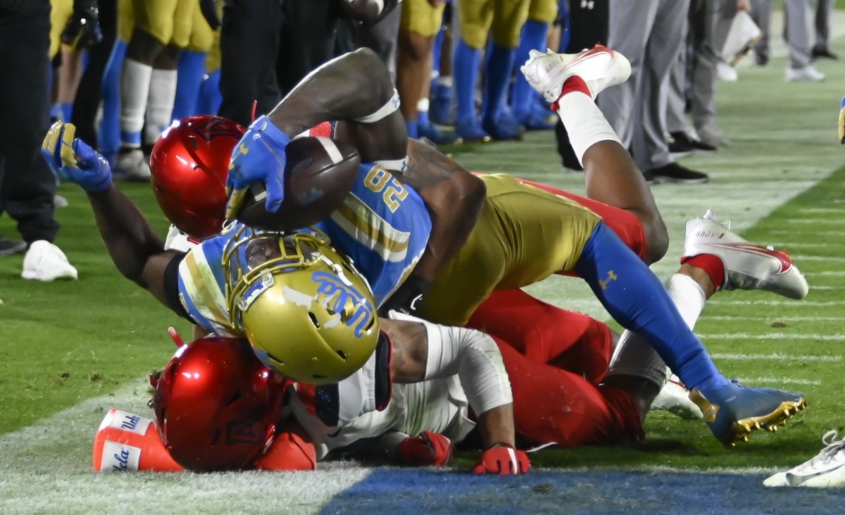 Nov 28, 2020; Pasadena, California, USA; UCLA Bruins running back Brittain Brown (28) falls into the end zone to score touchdown in the fourth quarter against the Arizona Wildcats at Rose Bowl.