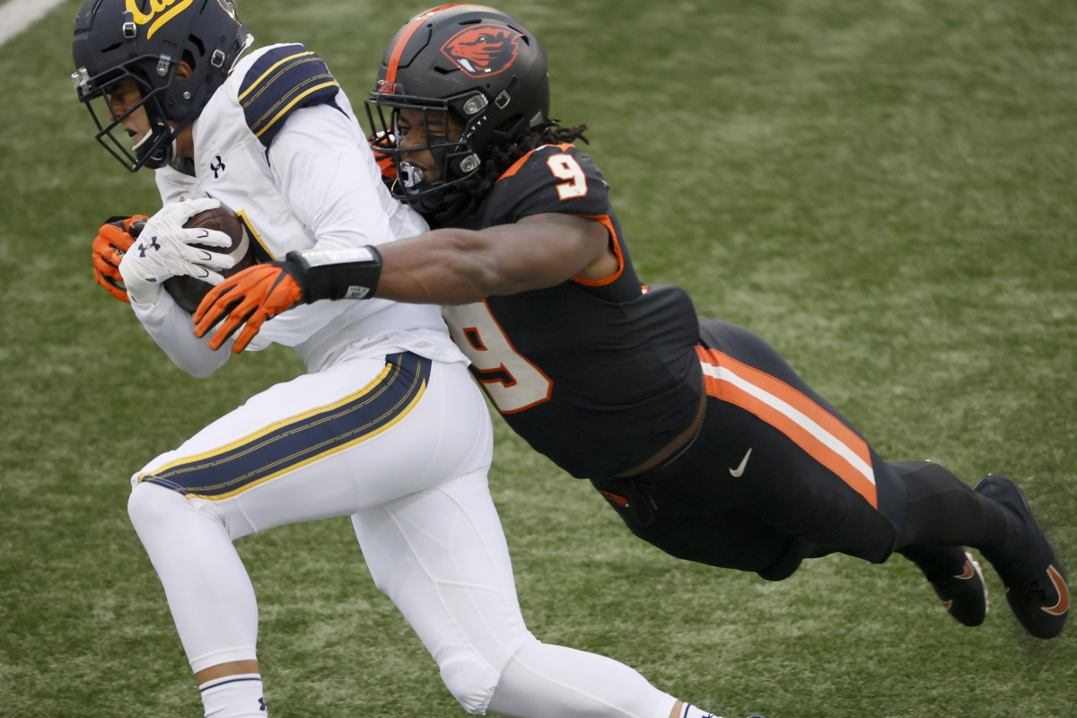 Nov 21, 2020; Corvallis, Oregon, USA; California Golden Bears wide receiver Monroe Young (14) is tackled by Oregon State Beavers linebacker Hamilcar Rashed Jr. (9) during the second half at Reser Stadium.