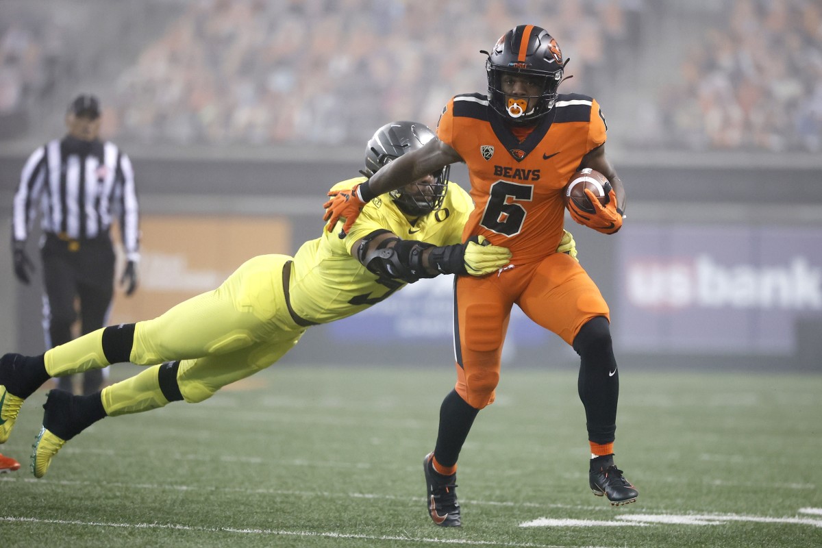 Nov 27, 2020; Corvallis, Oregon, USA; Oregon State Beavers running back Jermar Jefferson (6) runs the ball against Oregon Ducks defensive end Kayvon Thibodeaux (5) during the first half at Reser Stadium.