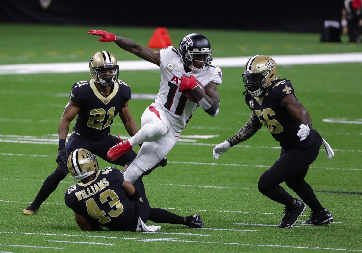 Nov 22, 2020; New Orleans, Louisiana, USA; Atlanta Falcons wide receiver Julio Jones (11) is tackled by New Orleans Saints free safety Marcus Williams (43) and outside linebacker Demario Davis (56) and cornerback Patrick Robinson (21) during the first quarter at the Mercedes-Benz Superdome. Mandatory Credit: Derick E. Hingle-USA TODAY Sports