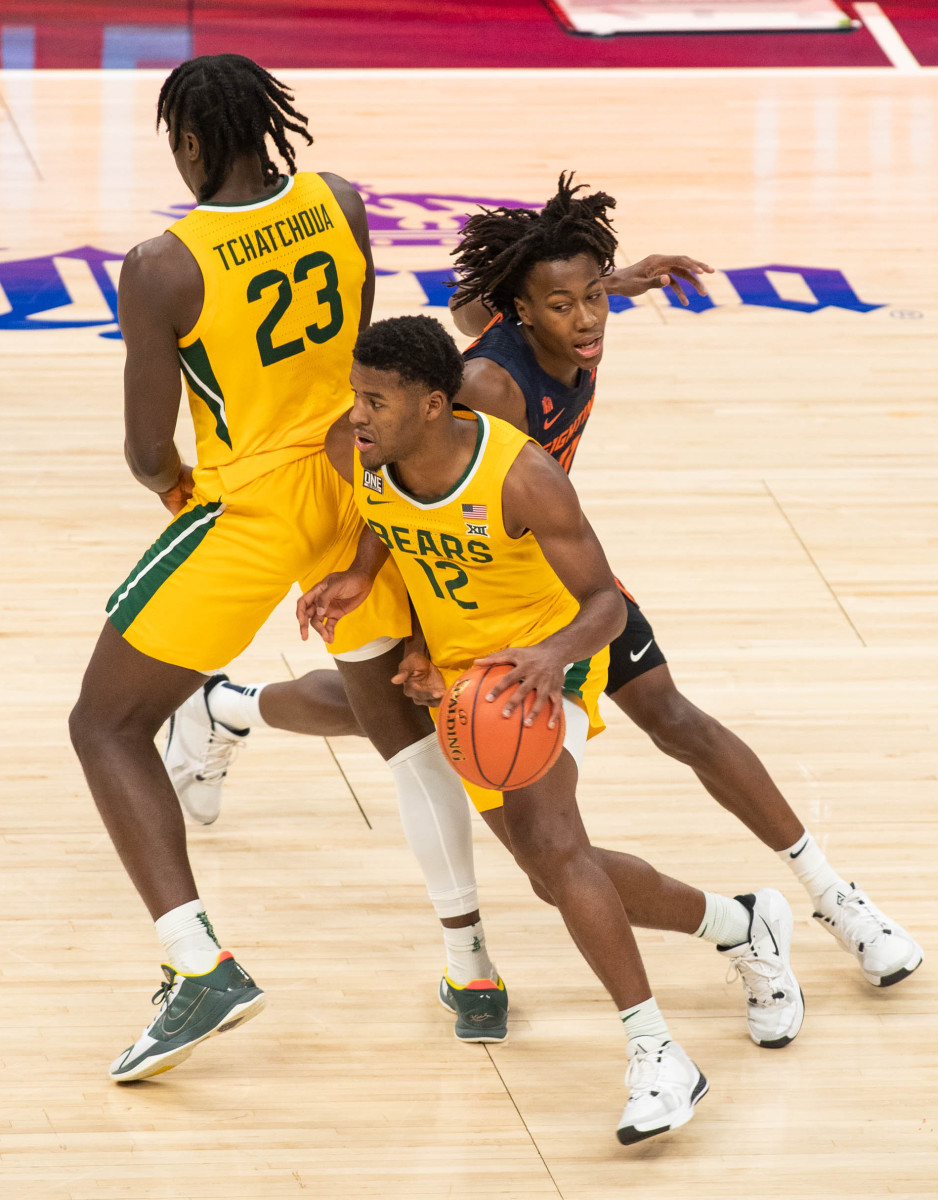 Baylor Bears guard Jared Butler (12) dribbles the ball against Illinois Fighting Illini guard Ayo Dosunmu (11) in the second half at Bankers Life Fieldhouse.Trevor Ruszkowski-USA TODAY Sports