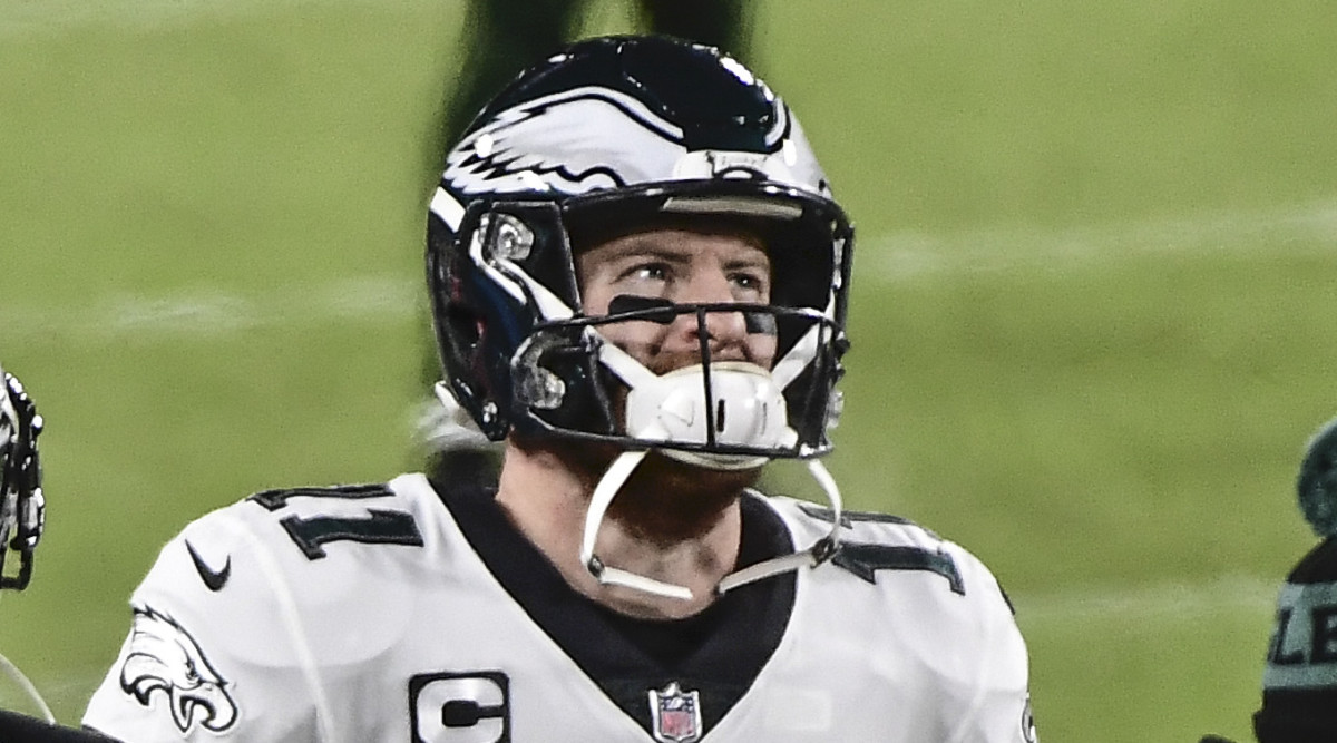 Philadelphia Eagles quarterback Carson Wentz (11) watches the game from the sidelines in the third quarter during the game against the Green Bay Packers at Lambeau Field.