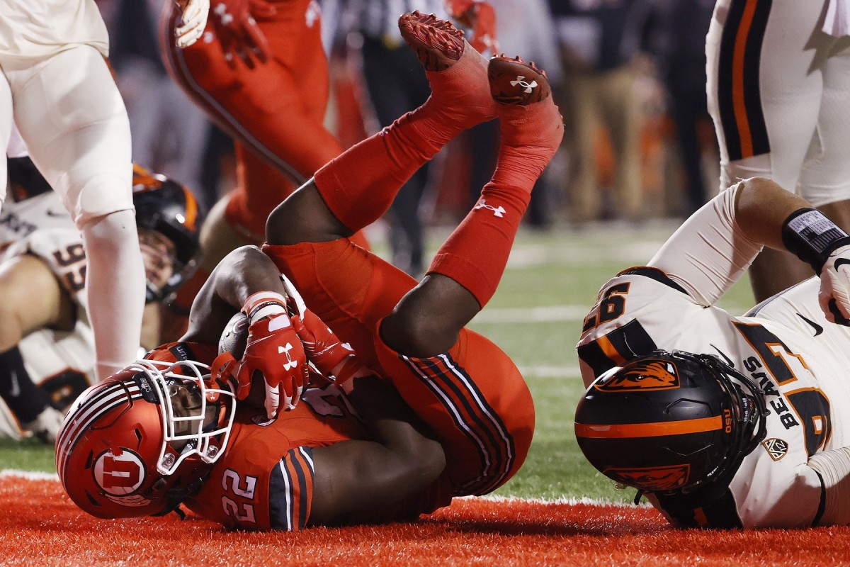 Dec 5, 2020; Salt Lake City, Utah, USA; Utah Utes running back Ty Jordan (22) runs for a touchdown against Oregon State Beavers defensive lineman Alexander Skelton (97) in the second quarter at Rice-Eccles Stadium.