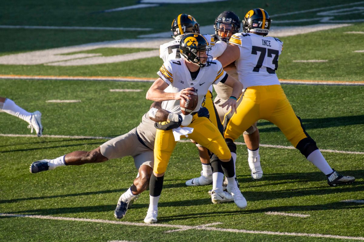 Illinois Fighting Illini linebacker Khalan Tolson (45) sacks Iowa Hawkeyes quarterback Spencer Petras (7) during the first half of the 2020 game at Memorial Stadium.