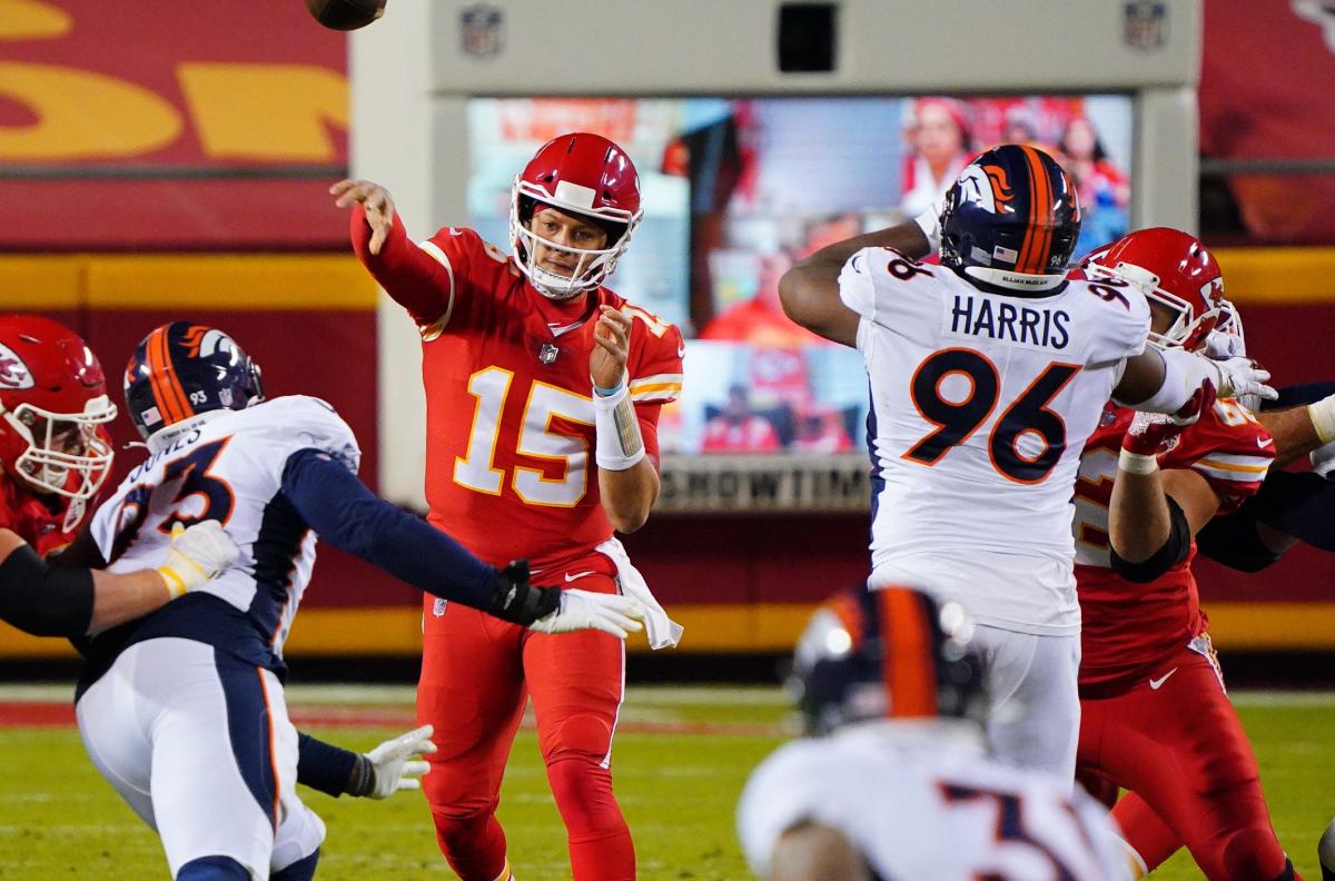 Kansas City Chiefs quarterback Patrick Mahomes (15) throws a pass ahead of Denver Broncos defensive end Shelby Harris (96) during the first half at Arrowhead Stadium.