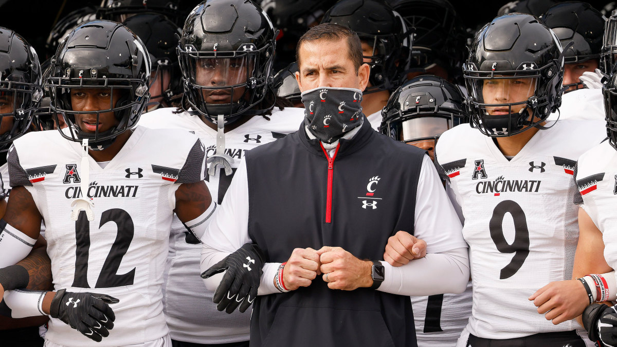 Cincinnati coach Luke Fickell walks out with his players for a game