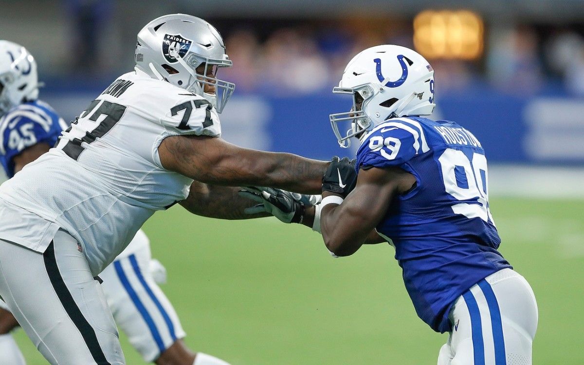 Indianapolis Colts defensive end Justin Houston (99) goes up against Las Vegas Raiders offensive right tackle Trent Brown on Sunday at Allegiant Stadium.