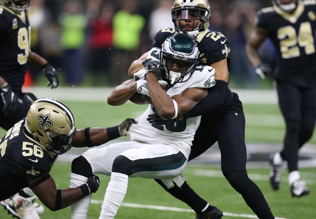 Jan 13, 2019; New Orleans, LA, USA; Philadelphia Eagles wide receiver Nelson Agholor (13) is tacked by New Orleans Saints outside linebacker Demario Davis (56) and cornerback Marshon Lattimore (23) during the first quarter of a NFC Divisional playoff football game at Mercedes-Benz Superdome. Mandatory Credit: Chuck Cook-USA TODAY 